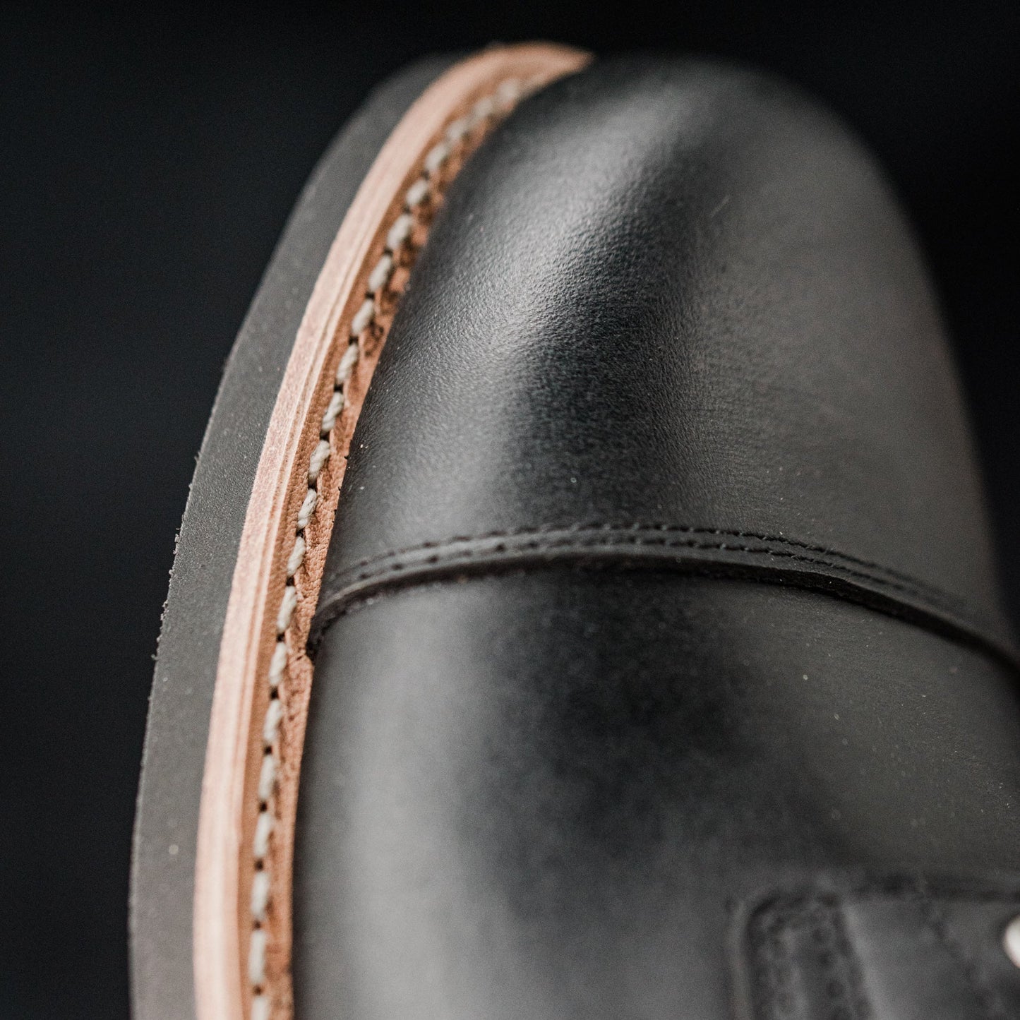 Close-up of the Tâmega boot’s stitched welt and black rubber outsole edge